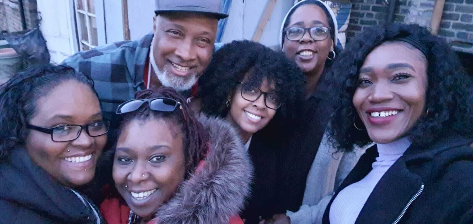 Tishauna Mullings, Black on Track Project Manager with one of the participants Clayton 'Milo' Myles of Flavours Caribbean Cuisine with his family supporting him as he provided food at an event in the Garden at Brixton Dominoes Club